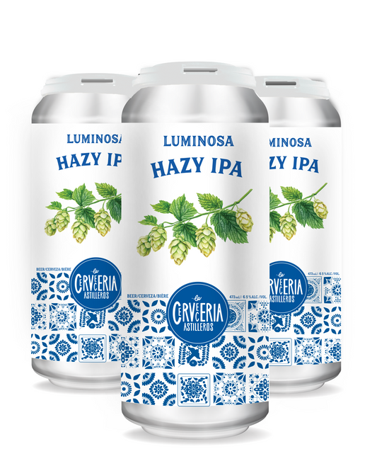 Glass of Luminosa Hazy IPA, a thick, juicy hazy IPA with tropical notes of peach, mango, and candied orange, served in a tulip glass, bright and refreshing.